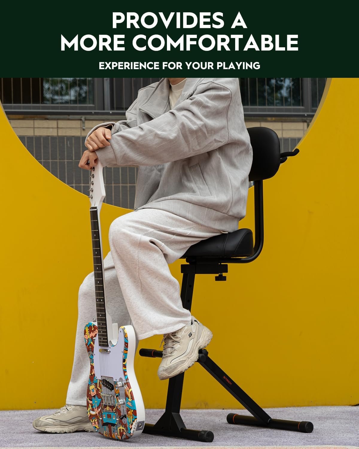 Guitar player sitting comfortably in a dedicated home music corner